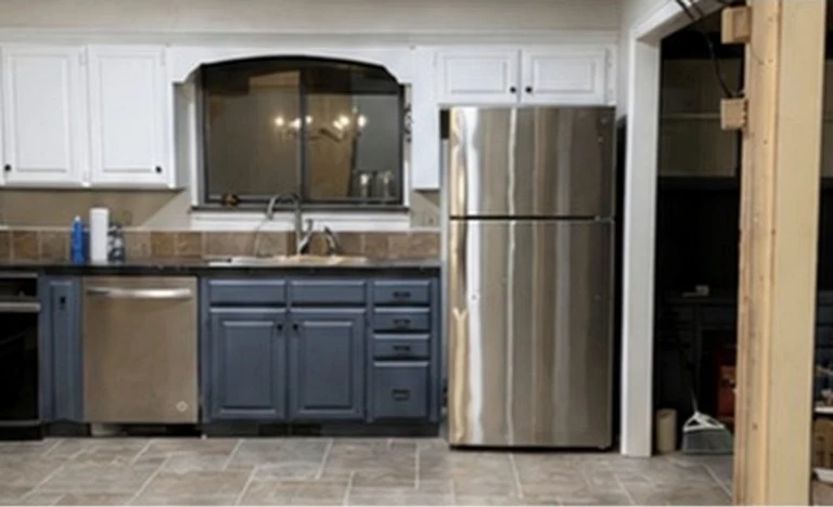 The kitchen as found, looking toward the sink and the arched pass-through