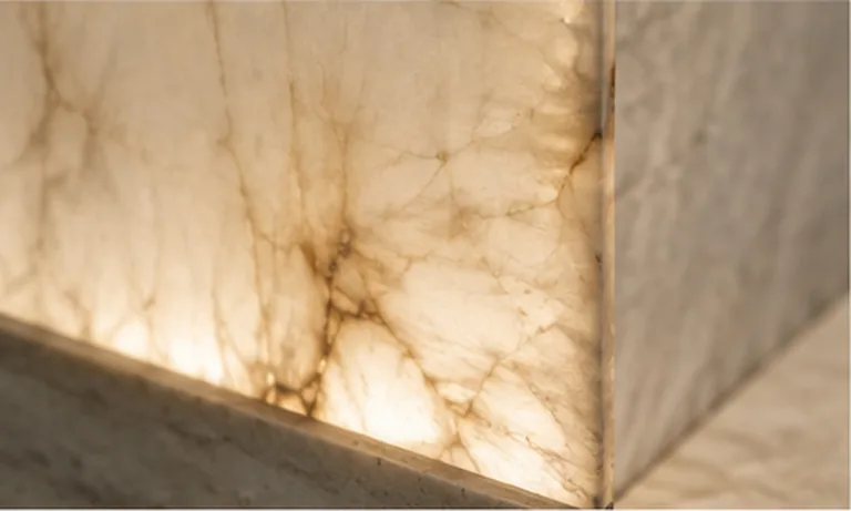 Backlit alabaster panel against honed stone
