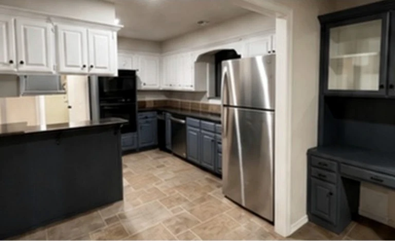The Ridge kitchen as found: navy and white cabinetry, tile floor, peninsula